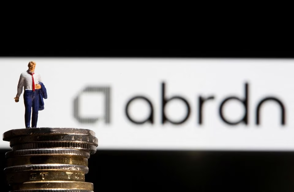 Reuters. FILE PHOTO: Businessman toy figure is placed on U.K. Pound coins in front of displayed Abrdn logo in this illustration taken, November 8, 2021. REUTERS/Dado Ruvic/Illustration/File Photo